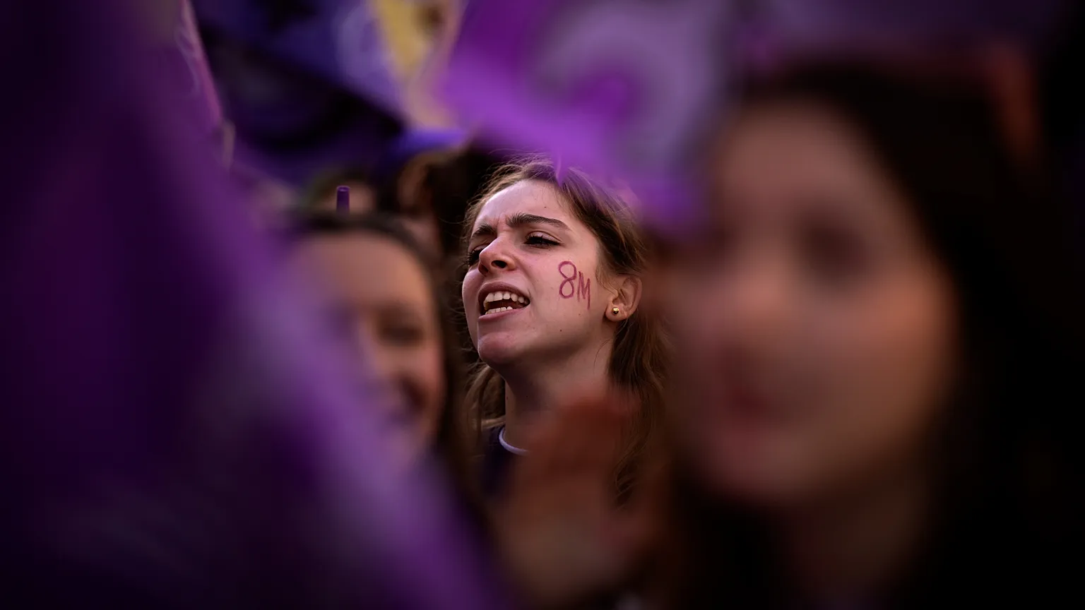 Students march during an International Women's Day protest in Barcelona, chanting slogan against violence against women