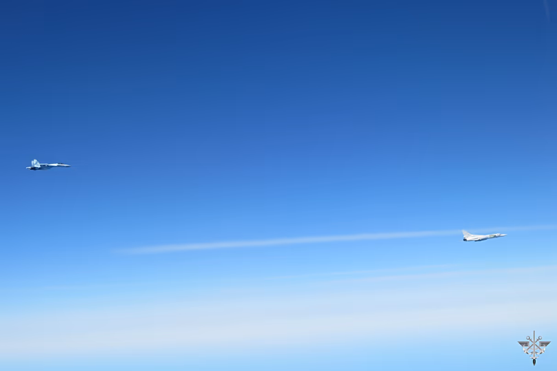 A Russian supersonic Tu-22M3 strategic bomber, right, and an escorting Su-35 Russian fighter jet fly together over the Baltic Sea, 20 April, 2026 