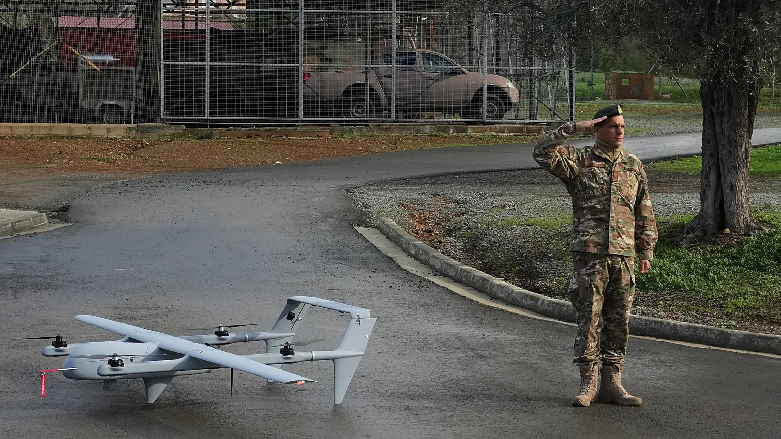 A soldier salutes as he stands next to an H-10 Poseidon drone at a military camp in Mosfiloti village, in the Nicosia district of Cyprus, Monday, Jan. 12, 2026. 