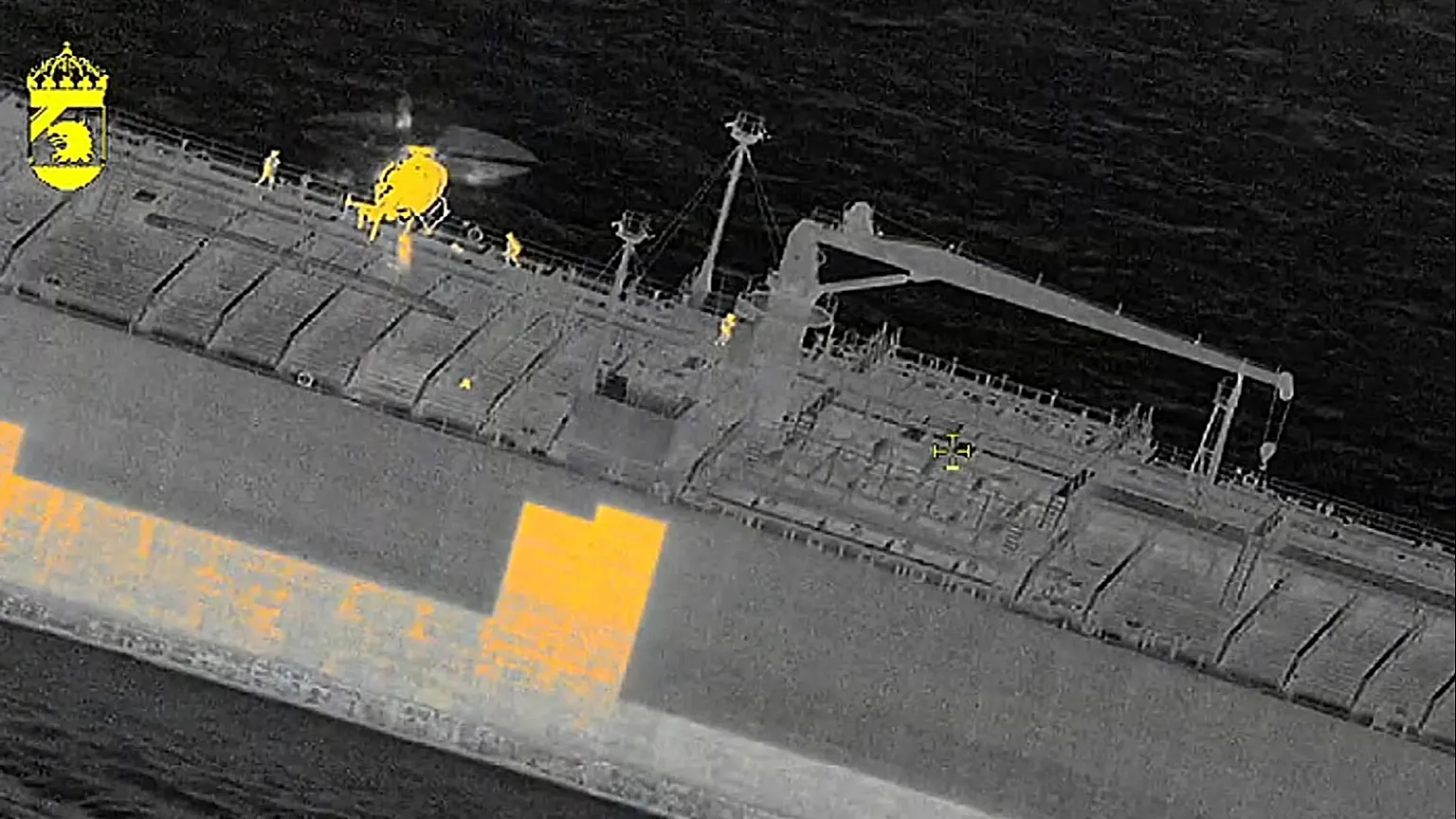 In this image made with a thermal imaging camera Swedish officials board the Sea Owl I tanker off the coast of Trelleborg, 12 March, 2026 