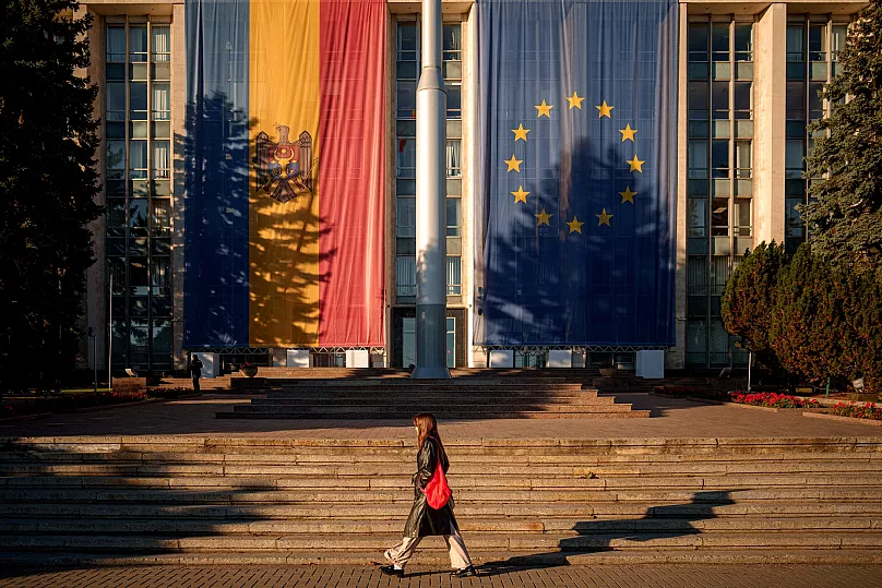 A woman walks in front of the government building decorated in Chișinău, 26 September, 2025