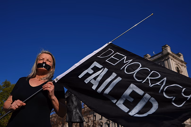 A campaigner holds a banner outside parliament in London as a proposed law to legalise assisted dying in England and Wales ran out of time, 24 April, 2026