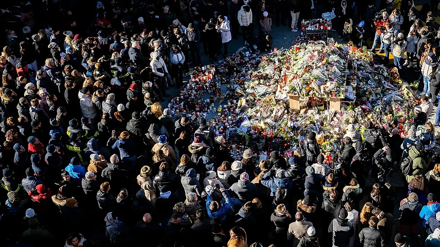 People gather during a memorial procession in Crans-Montana, 4 January, 2026