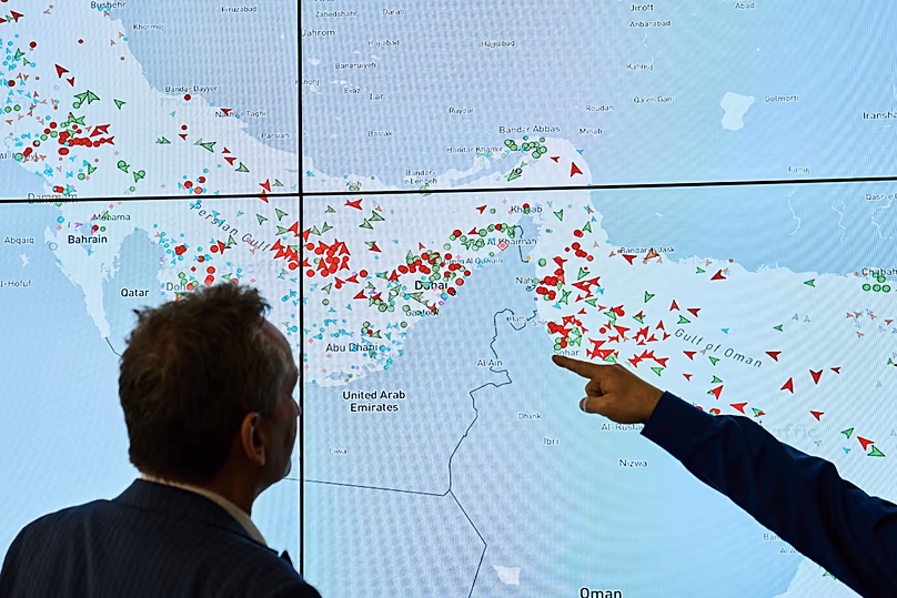 Hapag-Lloyd employees monitor the status of cargo ships in the Strait of Hormuz on a screen in Hamburg, 15 April, 2026