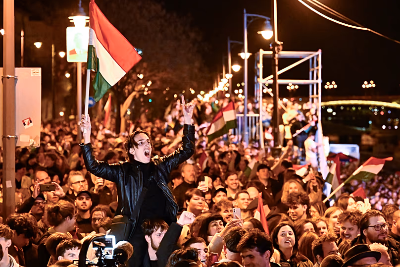 Supporters of Péter Magyar celebrate after a parliamentary election in Budapest, 12 April, 2026