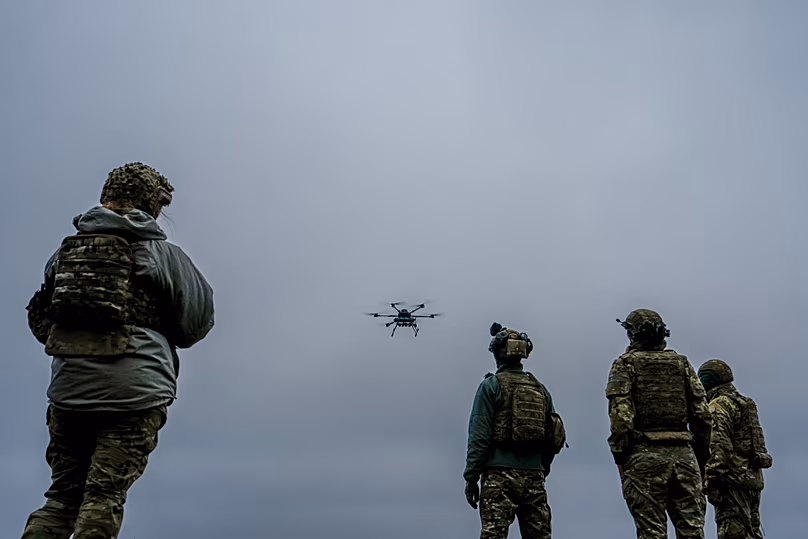  A Ukrainian drone operator from the Kraken 1654 unit flies a Vampire drone as other soldiers watch Nov. 5, 2025, in Kharkiv region, Ukraine. 