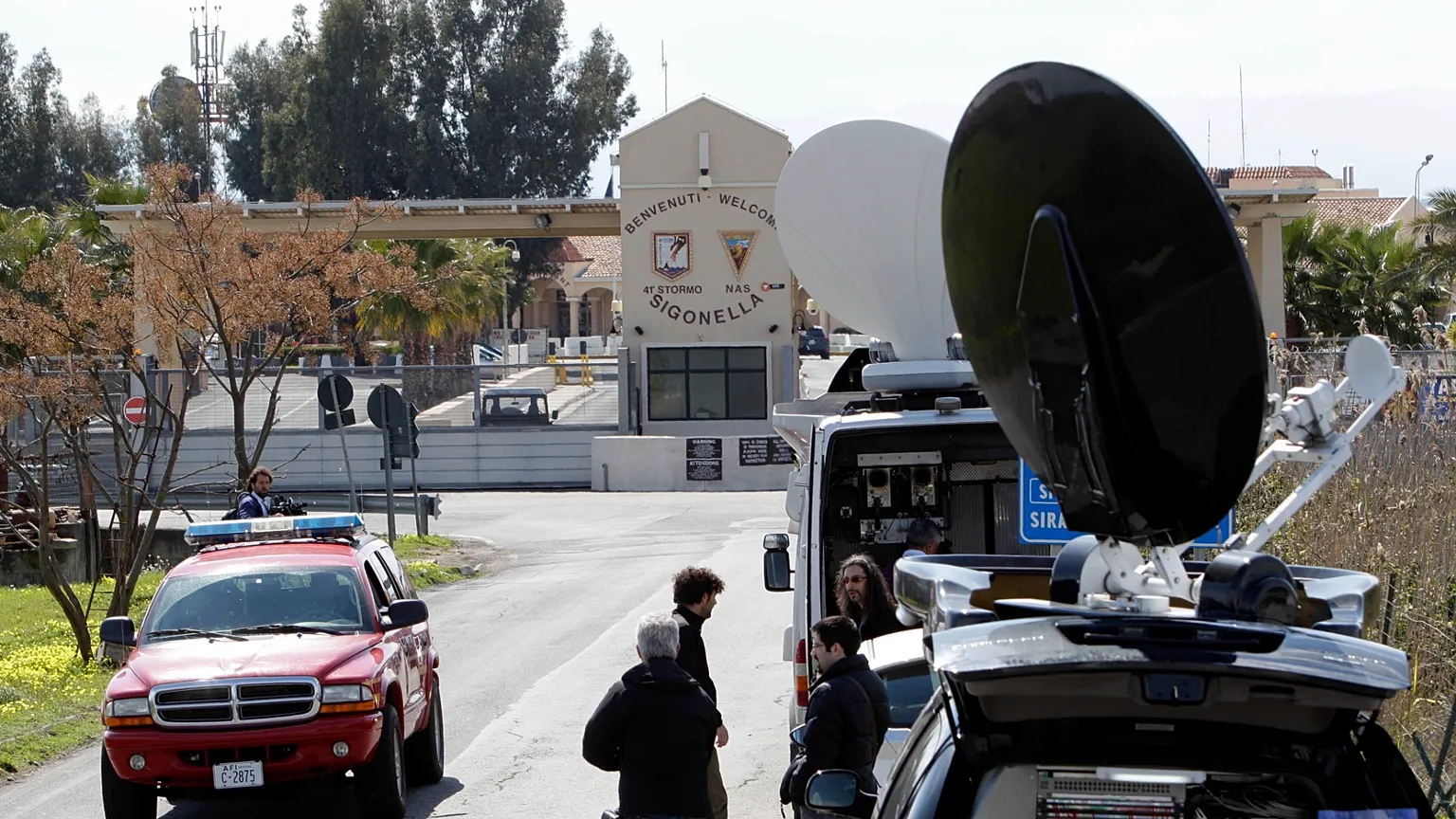 TV vans are parked outside the Sigonella NATO airbase. (AP Photo/Andrew Medichini)