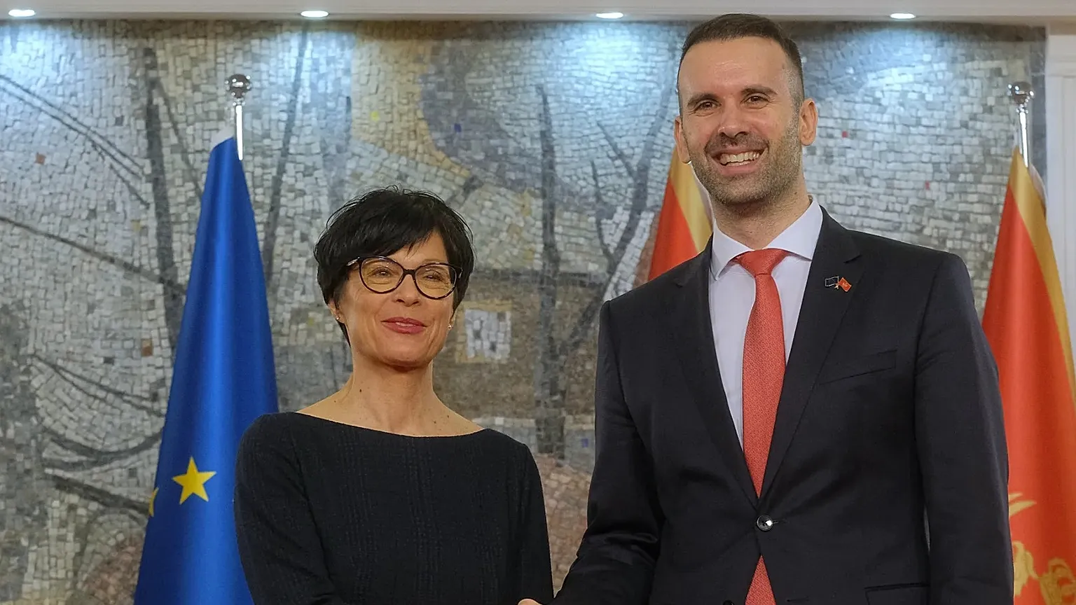 European Commissioner for Enlargement Marta Kos, left, shakes hands with Montenegro Prime Minister Milojko Spajic in Podgorica, Montenegro, Thursday, 26 March, 2026.