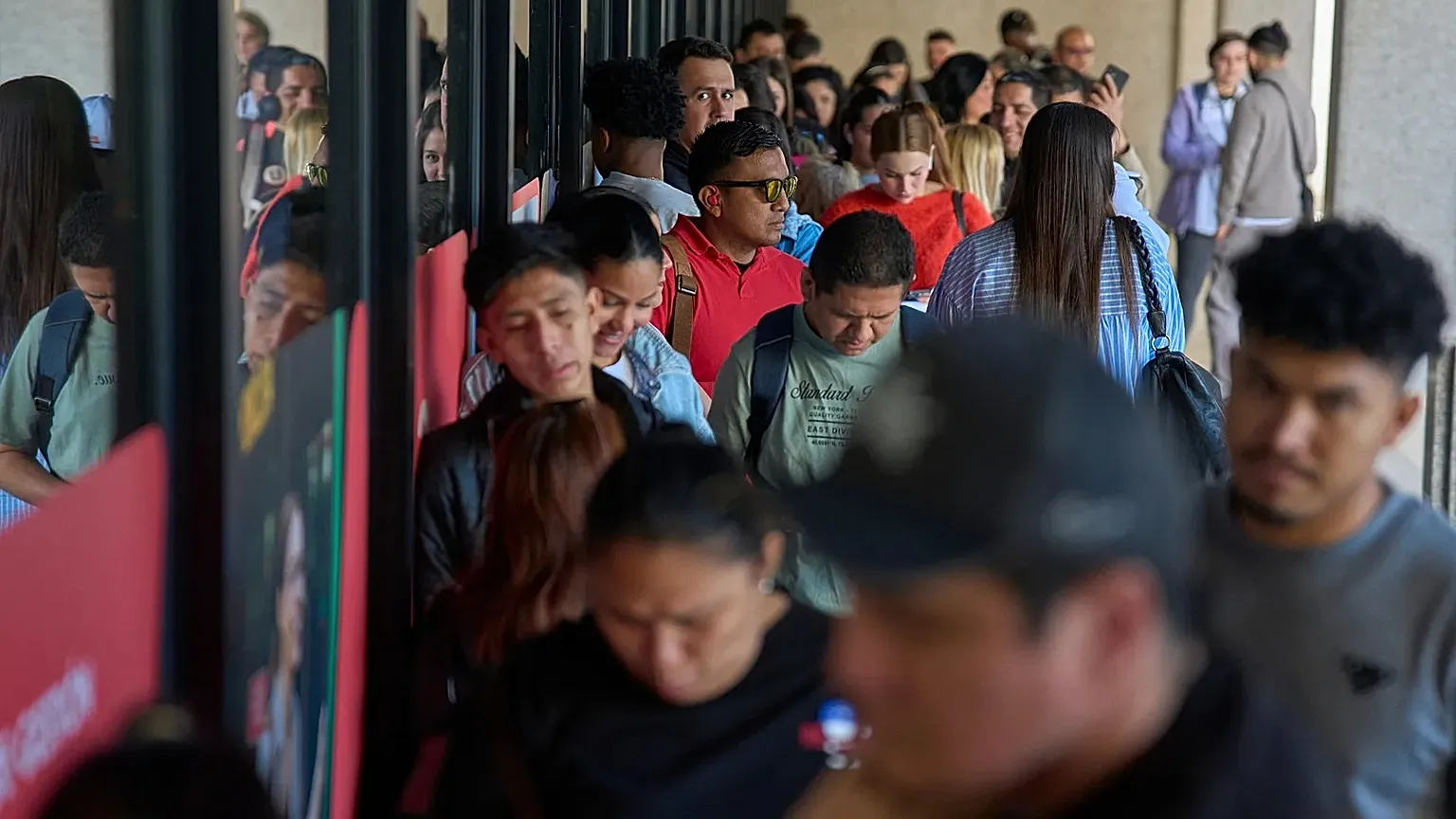 Immigrants queue to request public transport certificate in Madrid, 16 April, 2026