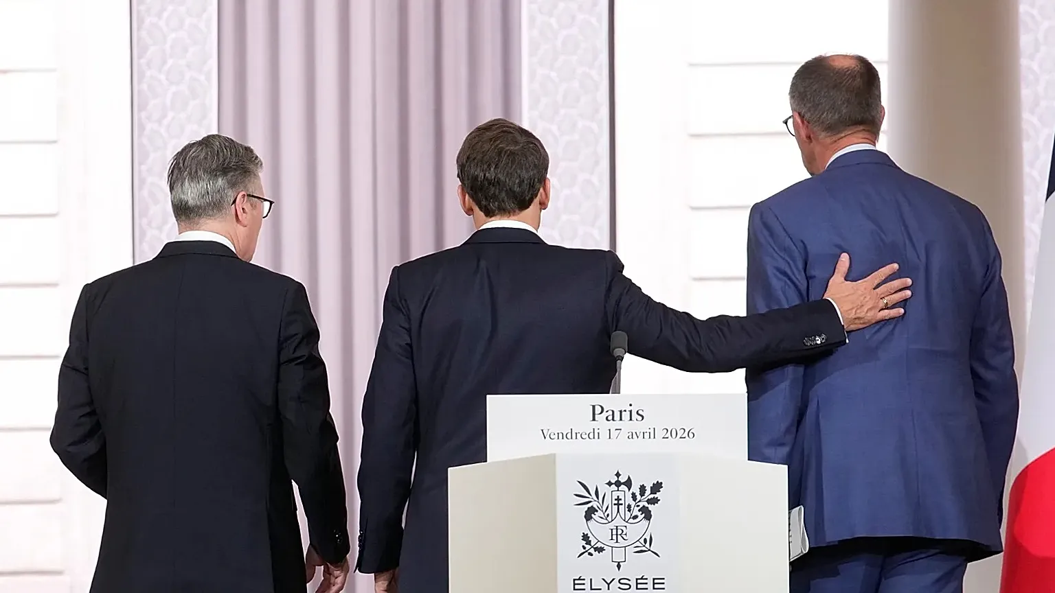 Britain's Prime Minister Keir Starmer, left, France's President Emmanuel Macron, center, and German Chancellor Friedrich Merz leave after they gave a statement in Paris