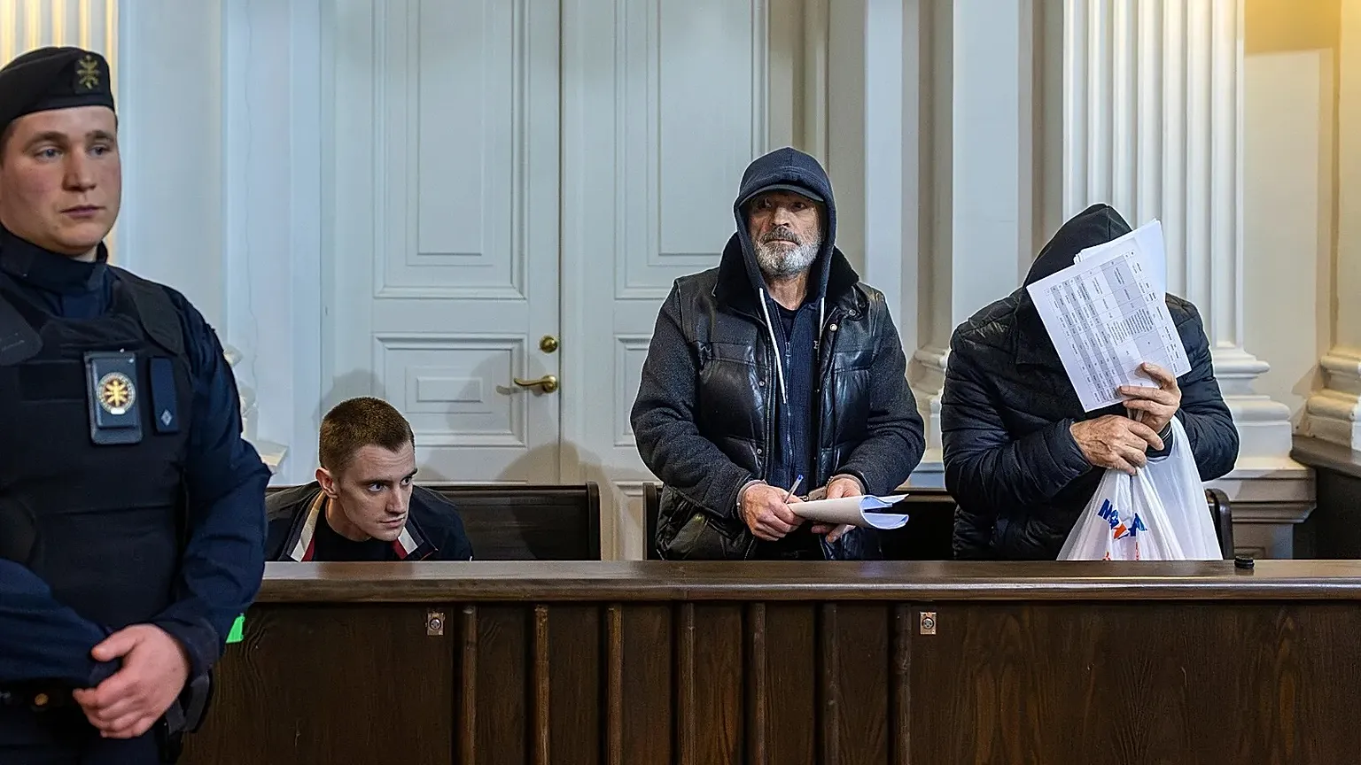 The suspects sit in the dock during their first hearing at district court in Vilnius, 17 April, 2026
