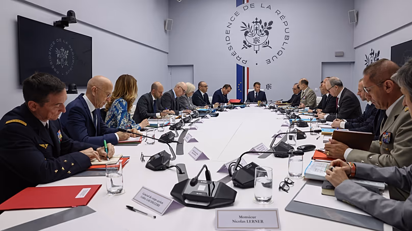 French President Emmanuel Macron, center, attends a meeting of France's defense and security council at the Elysee Palace in Paris, France, Wednesday, April 8, 2026.