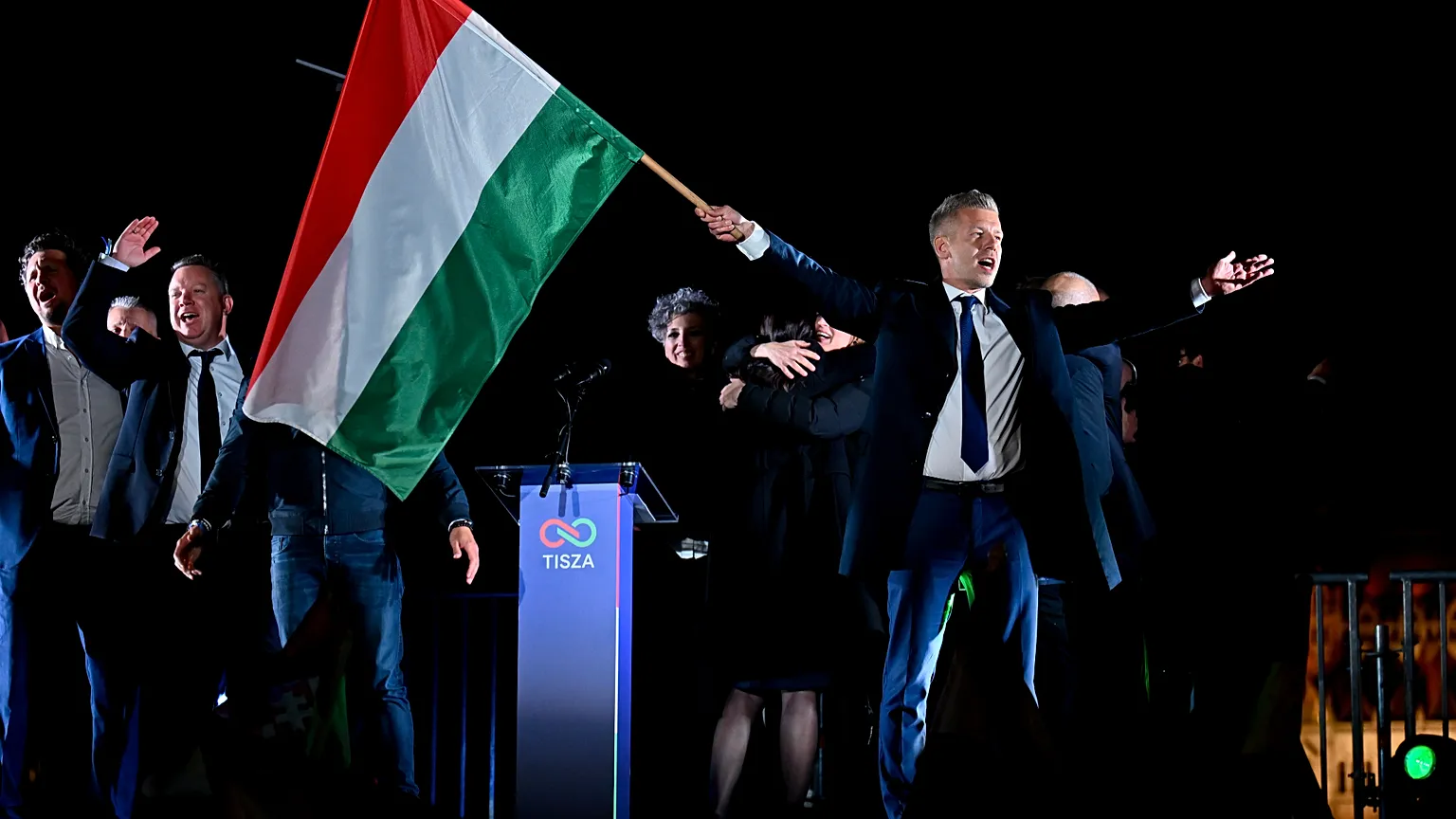 Peter Magyar, leader of the opposition Tisza party, waves the Hungarian flag following the announcement of the partial results of the parliamentary election, in Budapest.