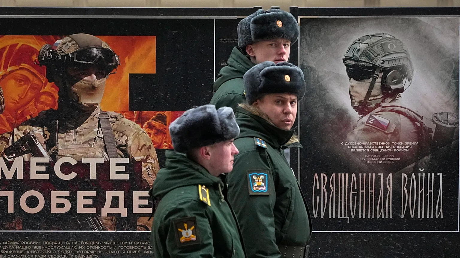 FILE: A military patrol passes by a street exhibition of military posters dedicated to Russian army in St Petersburg, 24 February 2025