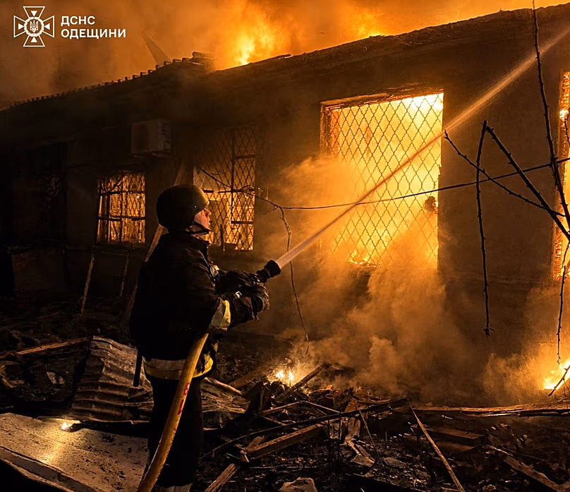 In this photo provided by the Ukrainian Emergency Service, firefighters put out a fire a building following a Russian drone attack in Odesa, Ukraine, Saturday, May 2, 2026
