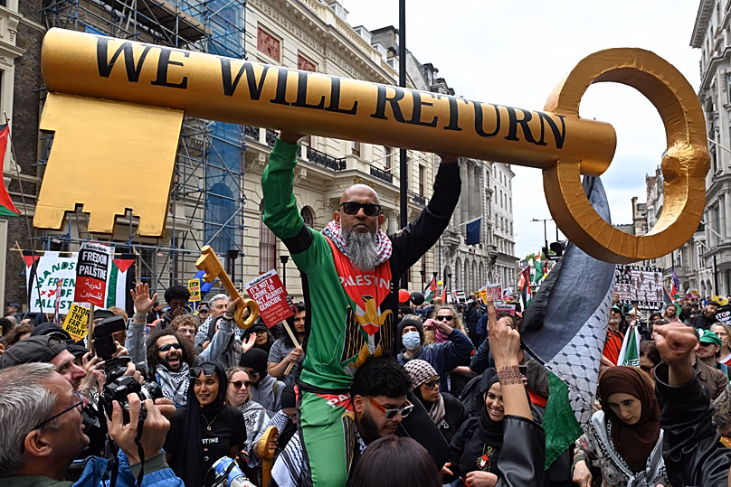 A protester show a giant key during a Pro-Palestine march in London, Saturday, May 16, 2026.