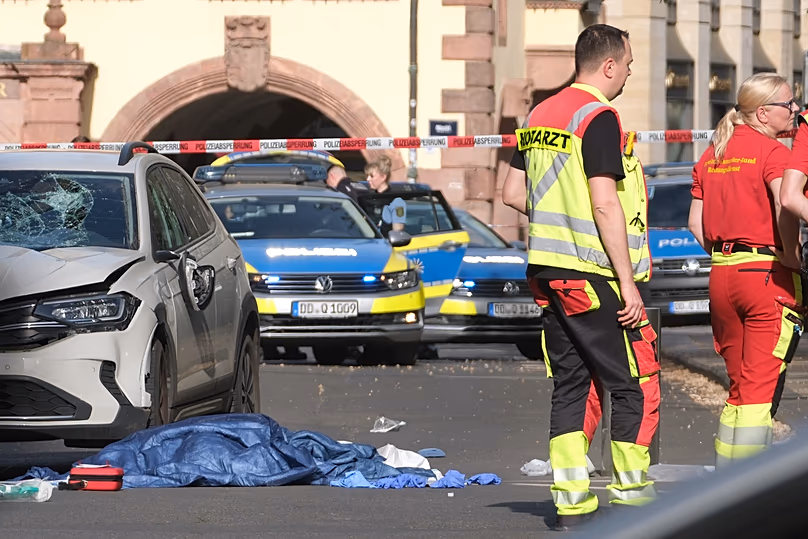 Rescue workers stand next to a damaged car that crashed into several people in Leipzig, 4 May, 2026