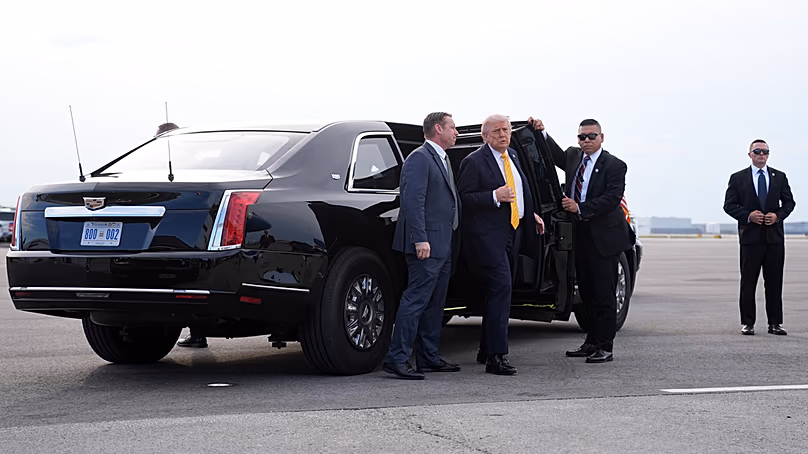 US President Donald Trump walks from his motorcade to talk to reporters before he boards Air Force One at Palm Beach International Airport in Florida, Saturday May 2, 2026