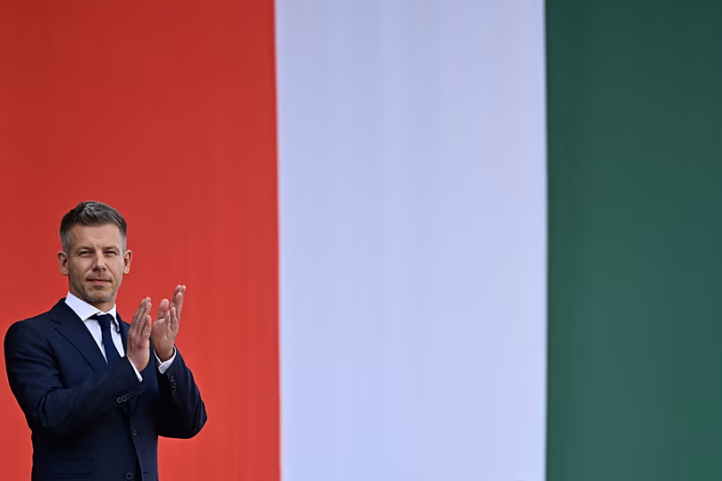 Hungarian Prime Minister Péter Magyar applauds in front of the Hungarian Parliament in Budapest, 9 May, 2026