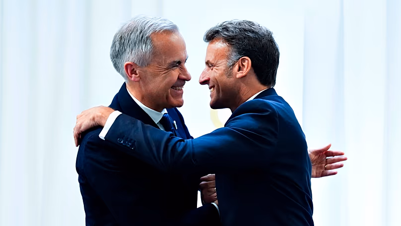 Mark Carney hugging Emmanuel Macron.