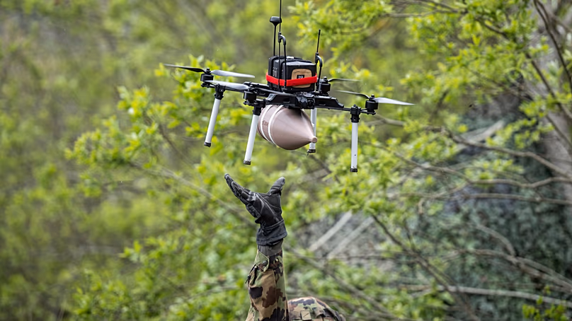 A soldier launches an attack drone during a press event held by the Swiss army in Elm, Switzerland, on 18 May 2026.