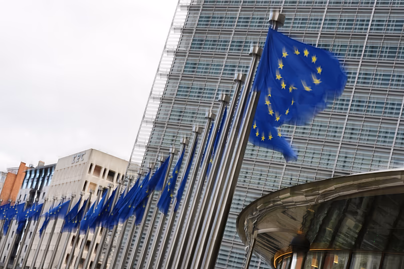 European Union flags flap in the wind outside EU headquarters in Brussels, 12 May, 2026