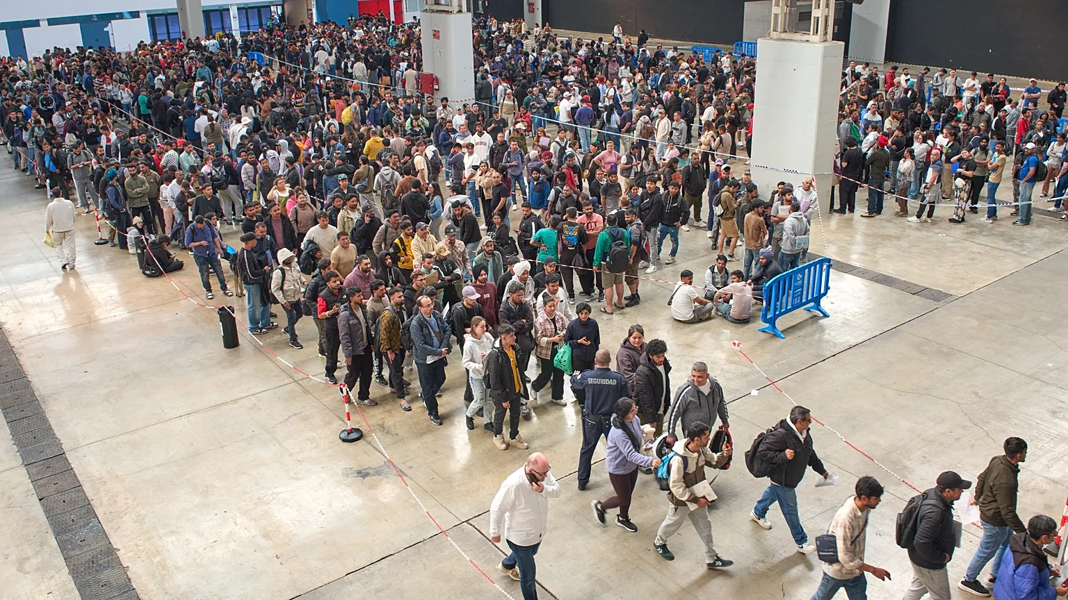 Migrants queue at public service office for paperwork to apply to Spain's immigration amnesty, 2`1 April 2026.