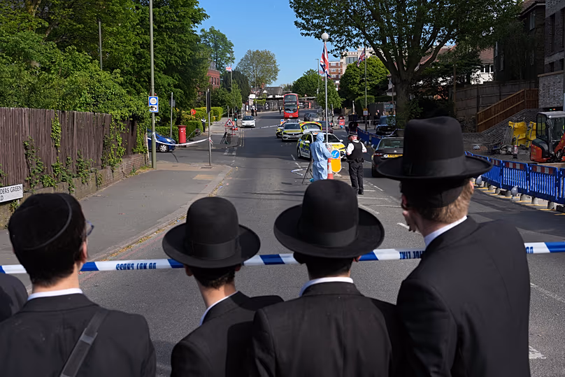 Members of the community watch as forensic officers search the area in the Golders Green neighbourhood, 29 April, 2026