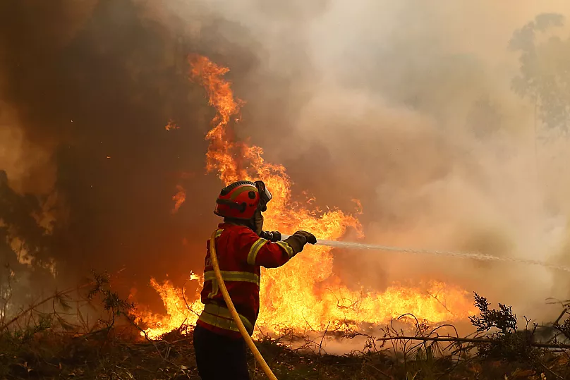 A firefighter works to extinguish a fire on the outskirts of Sever do Vouga, 18 September, 2024
