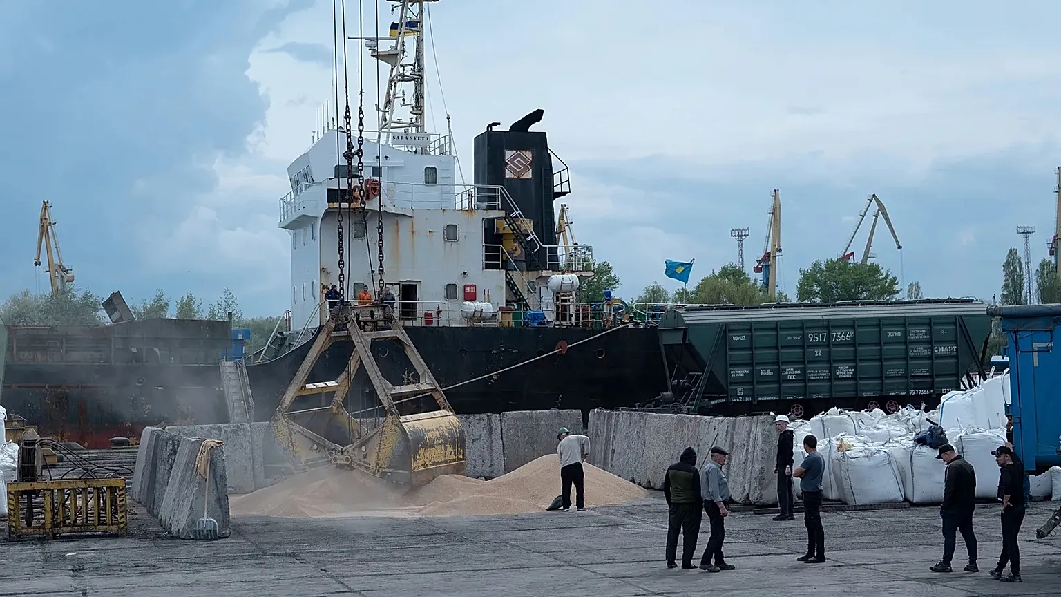 An excavator loads grain into a cargo ship at a grain port in Izmail, 26 April, 2023