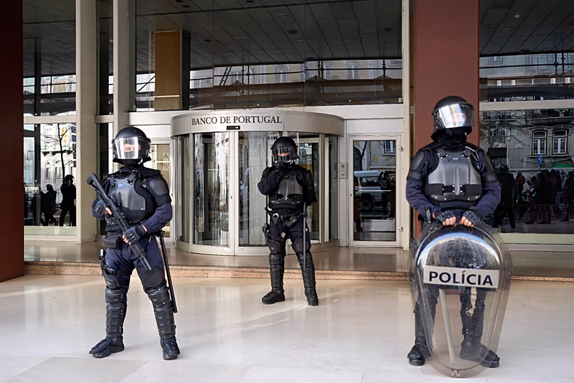 Police stand outside a building of the Bank of Portugal in Lisbon, 24 February, 2024 