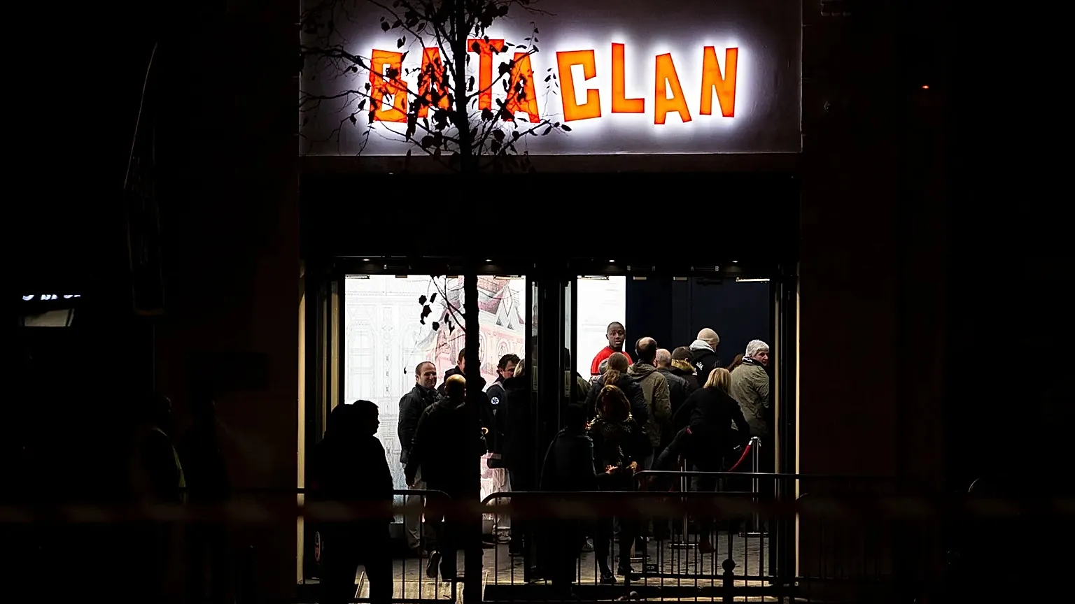 People enter the Bataclan concert hall in Paris, Saturday, Nov. 12, 2016. 