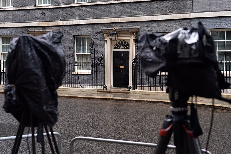 Cameras are covered with rain covers as journalists wait for a showing of Britain's Prime Minister Keir Starmer at 10 Downing Street in London, 11 May, 2026