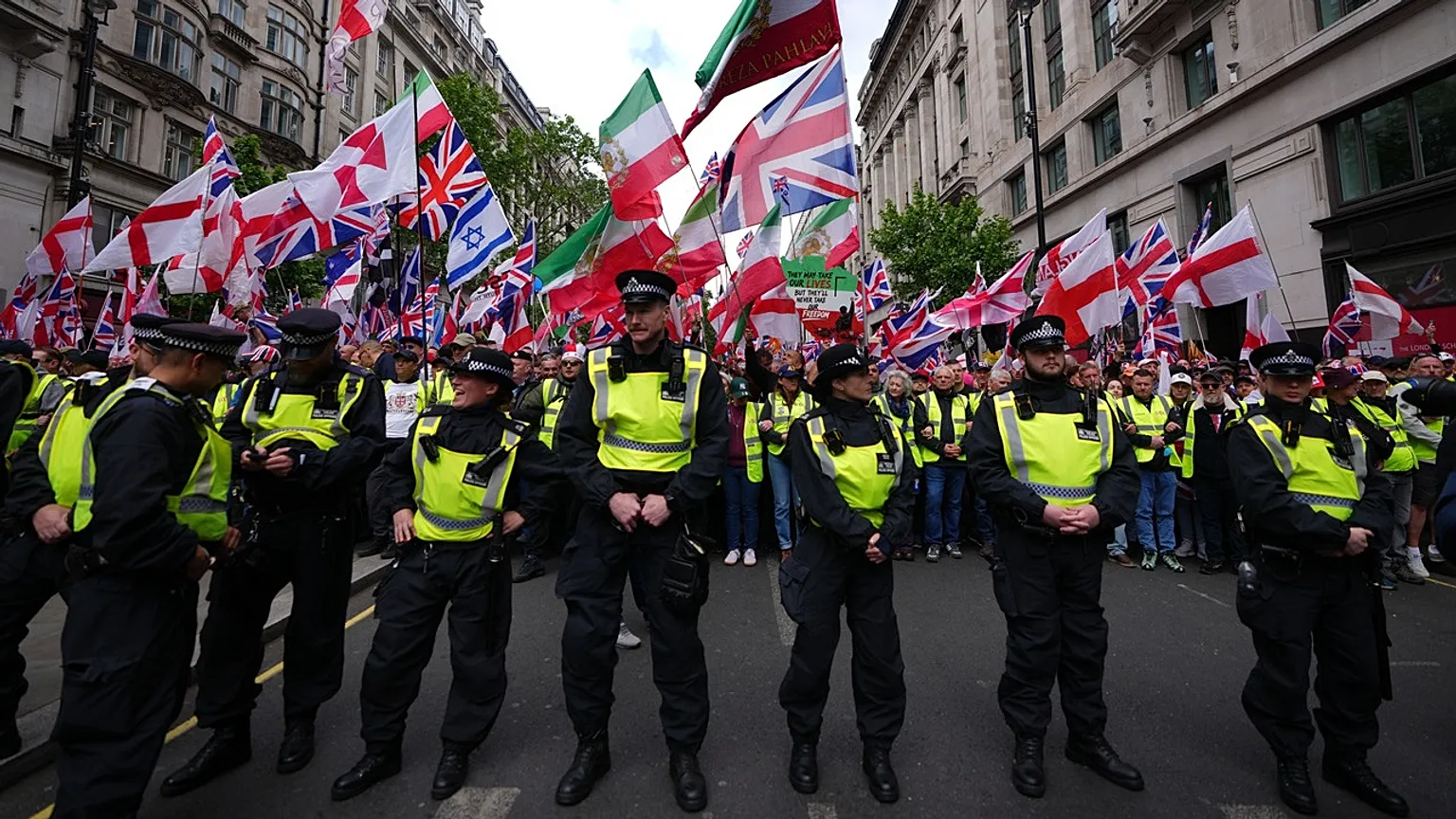 Police forces stand in front of the far right Unite the Kingdom march in London, Saturday, May 16, 2026.
