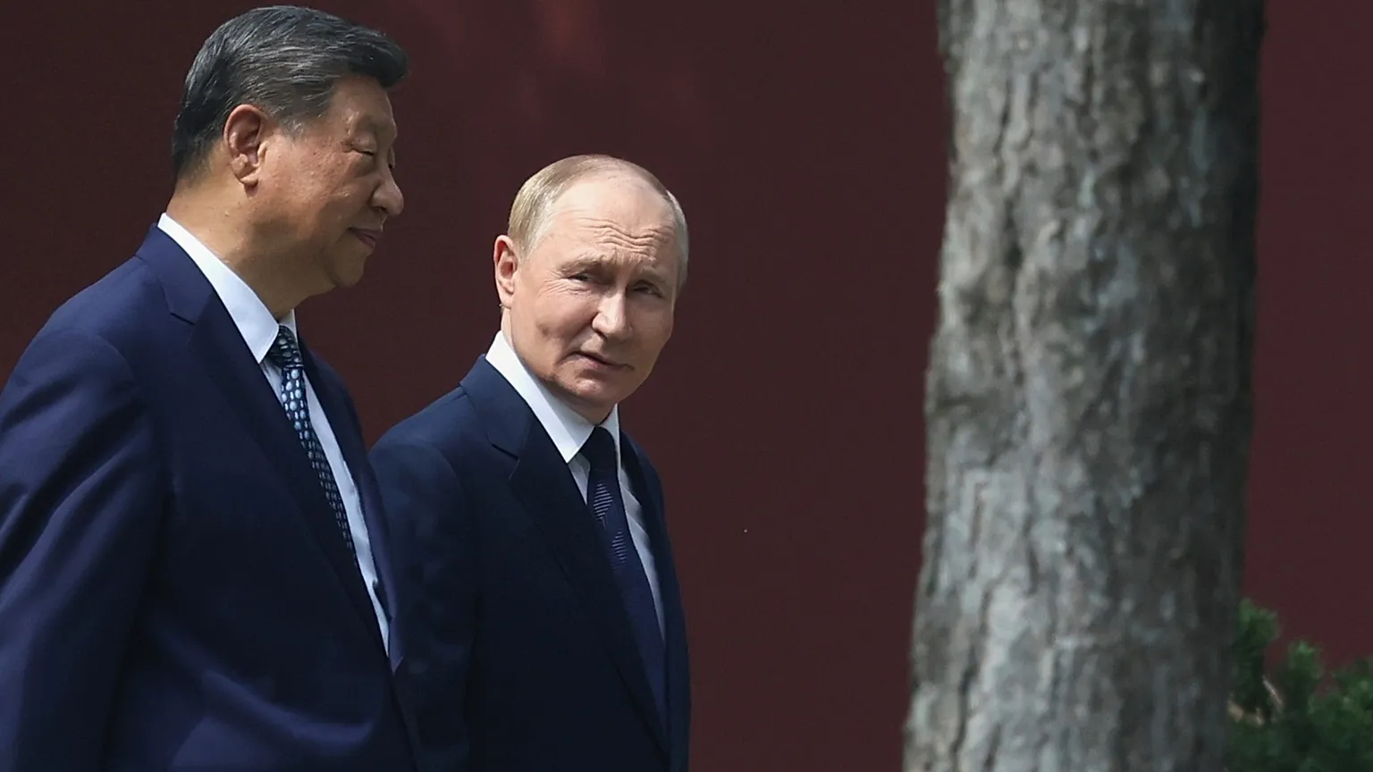 FILE: Vladimir Putin and Xi Jinping during a walk at the Zhongnanhai leadership compound in Beijing, China, Sept. 2, 2025.