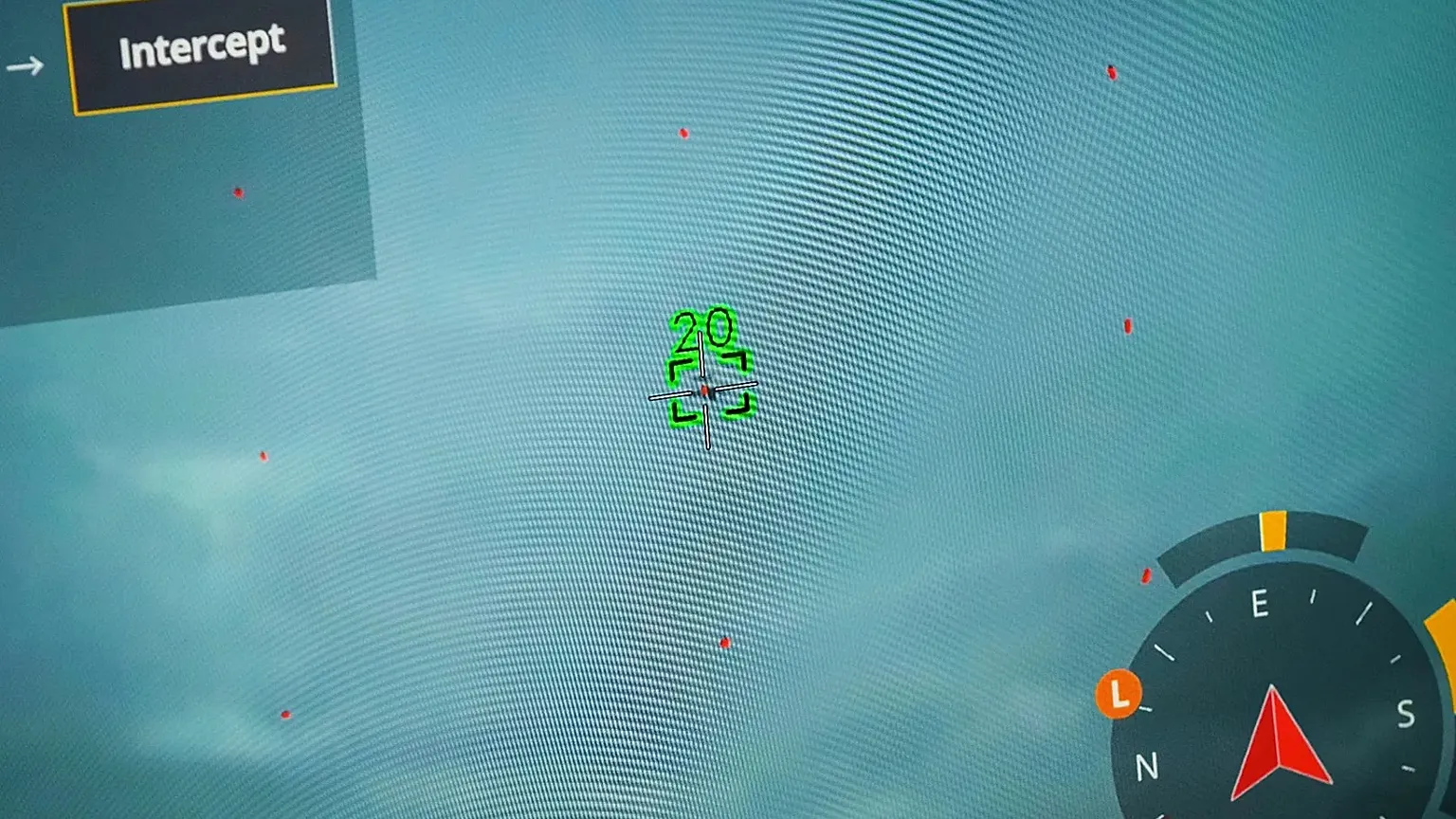 A drone pilot showing drone and target drone on monitor
