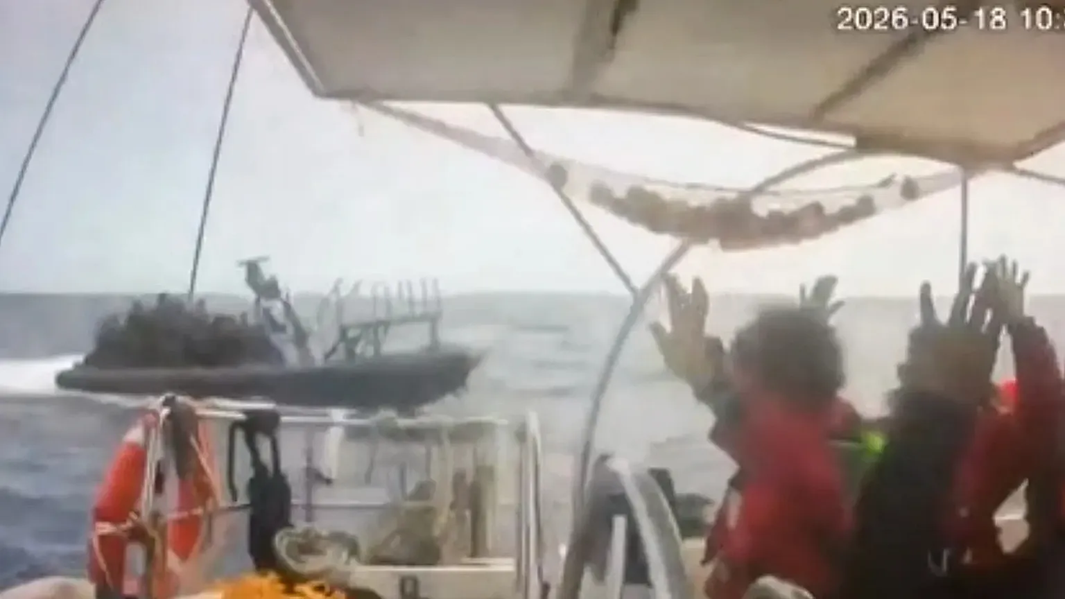 This grab from CCTV footage shows activists aboard a flotilla boat with their hands in the air as a boat approaches in international waters, 18 May, 2026