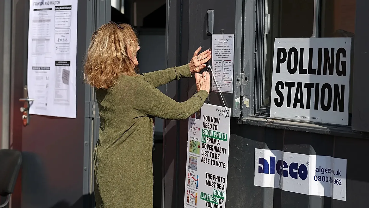 A worker prepares signs at a polling station in Walton on the Naze, 7 May, 2026