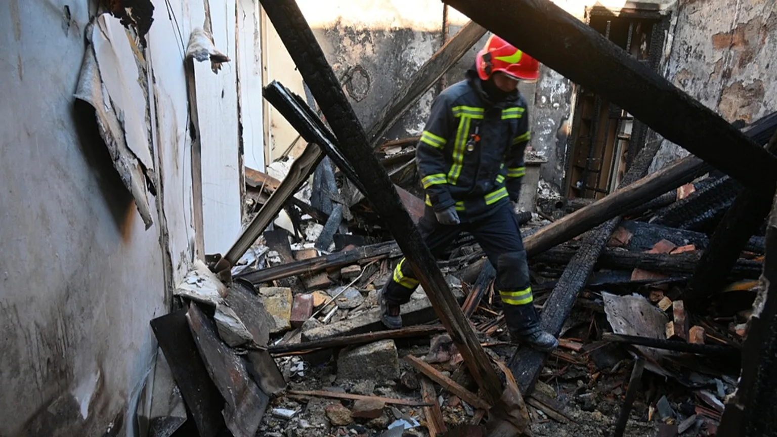 A rescue worker walks inside apartments destroyed by a Russian strike in Odesa, Ukraine, Monday, April 27, 2026