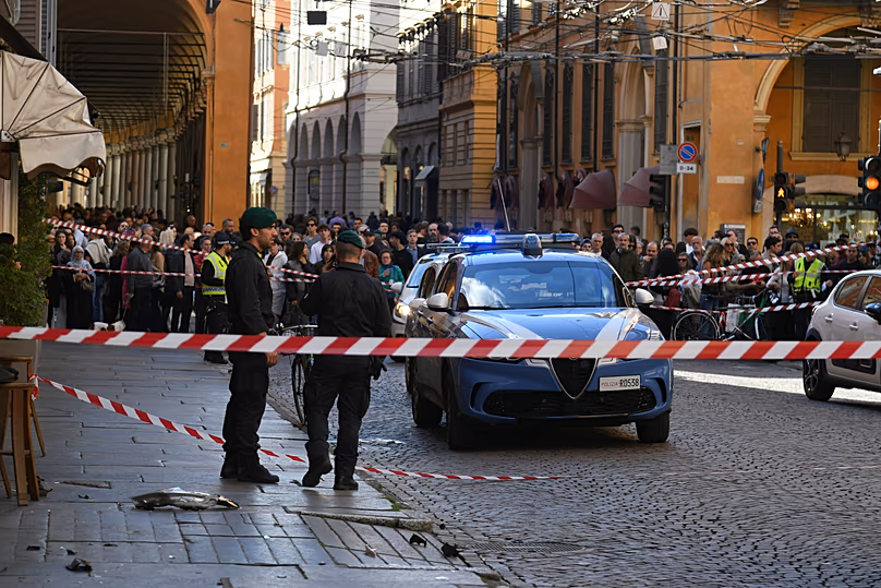 Police patrol a scene after a car incident in a street of Modena, Italy, Saturday, May 16, 2026. 