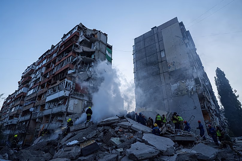 Rescue workers clear the rubble of a house heavily damaged after a Russian strike on residential neighbourhood in Kyiv, 14 May, 2026