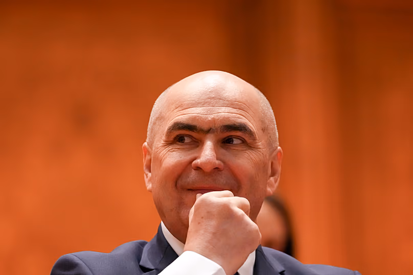 Romanian Prime Minister Ilie Bolojan grimaces during a parliament session ahead of a no confidence vote in Bucharest, 5 May, 2026
