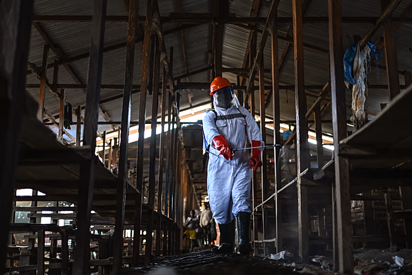 A sanitation worker from the Bunia city government sprays chlorine to disinfect the central market in Bunia, 23 May, 2026