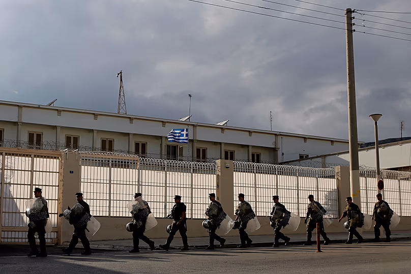 Riot police officers secure the outside of Korydallos maximum-security prison, in Athens, on Thursday, Oct. 3, 2013.