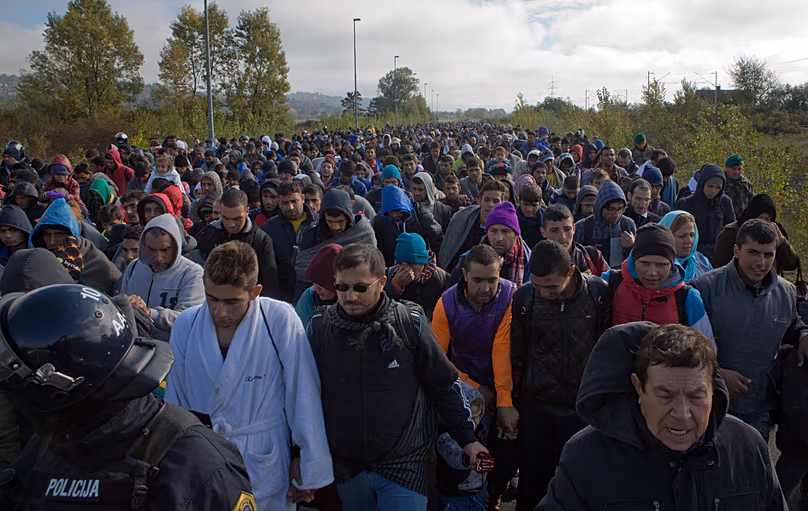 Migrants walk towards a reception facility after crossing from Croatia in Dobova in Slovenia, 20 October, 2015 