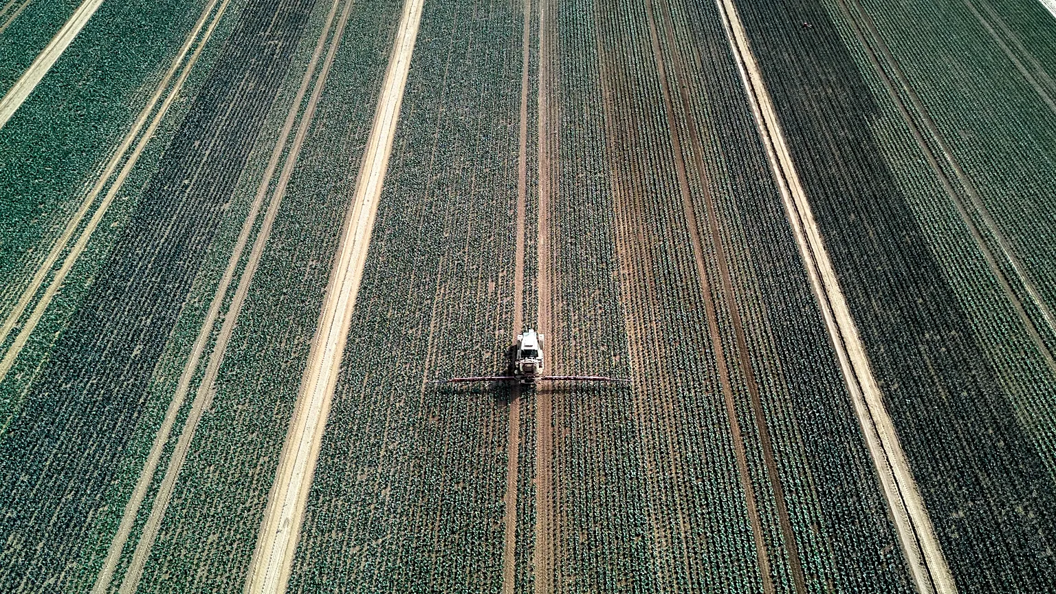A farmer fertilises a field in the outskirts of Frankfurt, Germany, Wednesday, May 21, 2025.