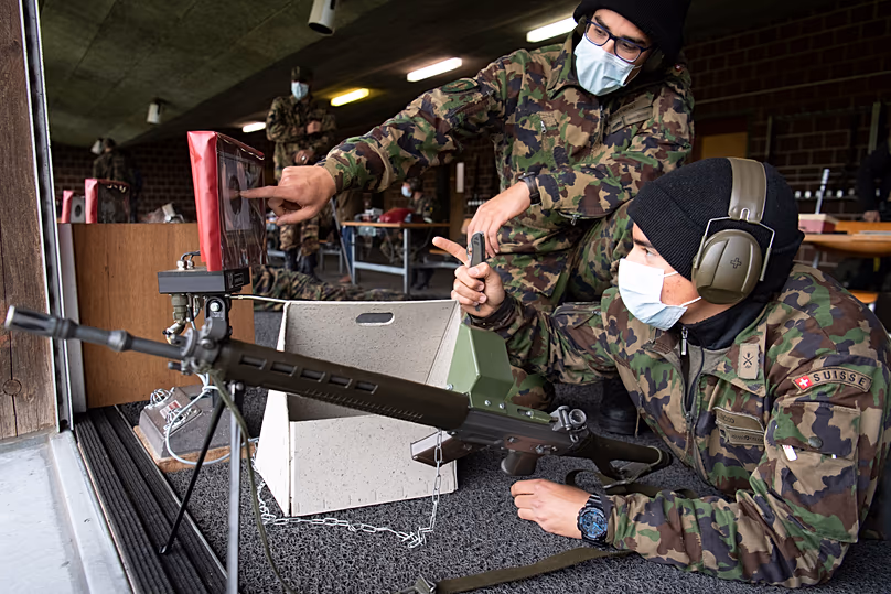 Soldiers of the Swiss army wear protective face masks during a rifle shooting exercise in the military compound of Chamblon near Yverdon-les-Bains, 30 April, 2020