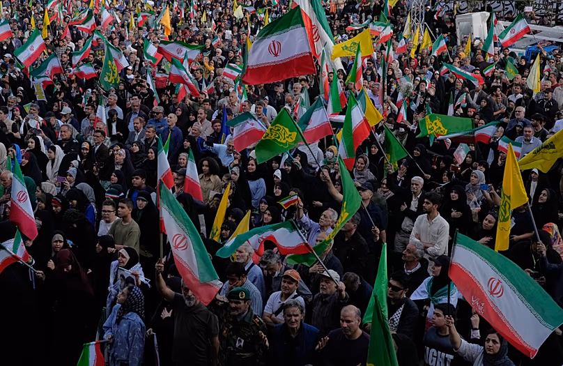 People wave Iranian flags during a state-organised rally in Tehran, 29 April, 2026