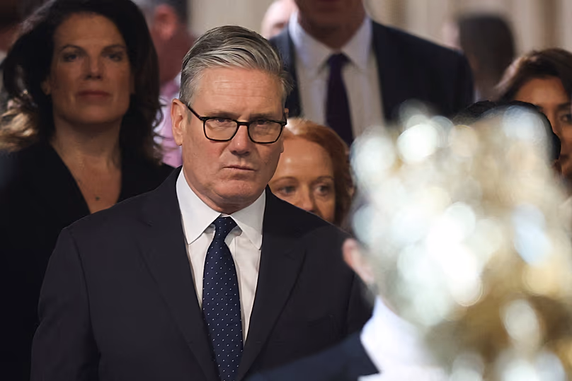 British Prime Minister Keir Starmer walks through the House of Commons to attend the State Opening of Parliament in London, 13 May, 2026