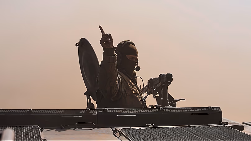 A commander sits in a battle vehicle Fuchs in the dust during a visit of Chancellor Friedrich Merz to the army at the Bundeswehr base in Munster, Germany, April, 30, 2026.